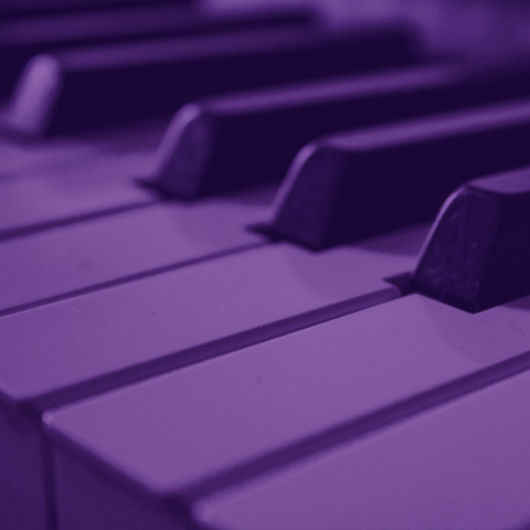 purple colored photo of piano keys