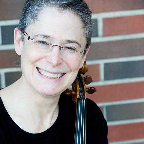 Sharon Leventhal smiling with her violin