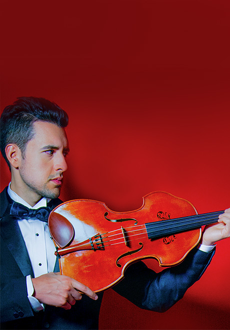 Photo of Paul Laraia holding viola with a red background