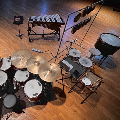 Photo of drum set, timpani, cymbals, chimes, marimba, and other auxiliary percussion instruments.