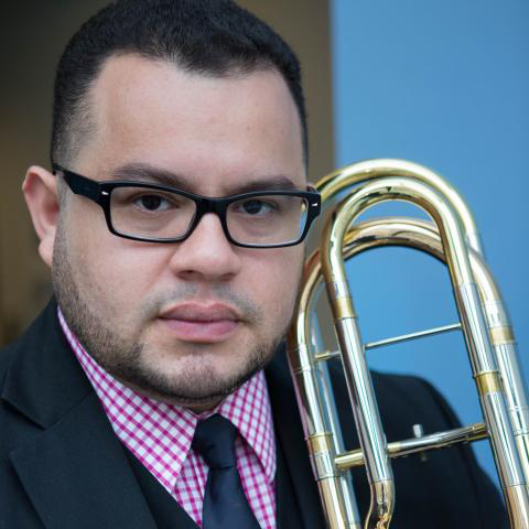 Angel Subero holding trombone