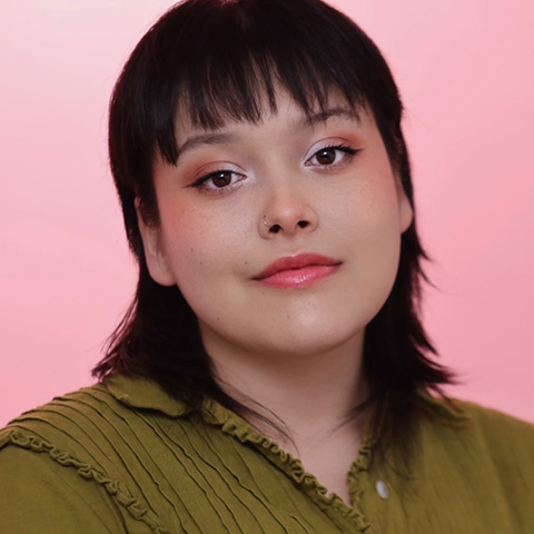 Lillian Salazar headshot: wearing green shirt in front of pink background