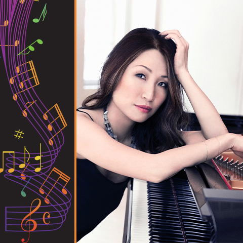 woman in blue dress sits at a piano 