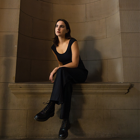 a woman sits on a window 