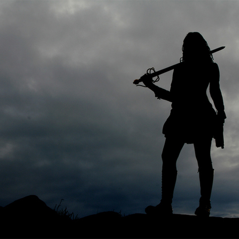 warrior woman standing with a sword 