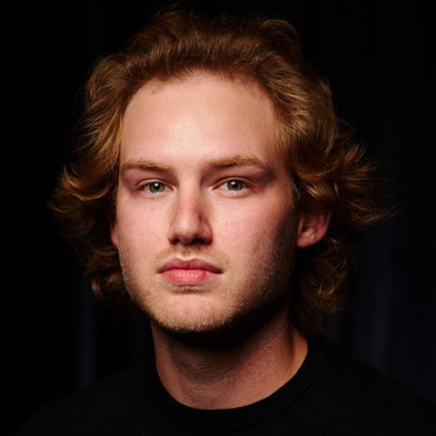 Matthew Carey headshot with a black background