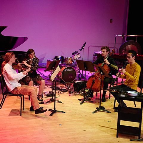 students playing on a stage