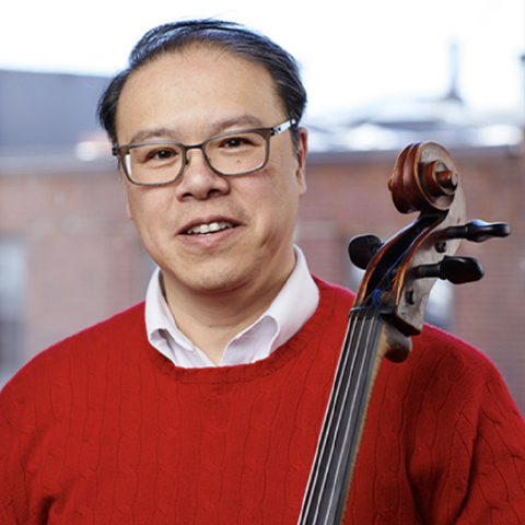 Cellist Andew Mark poses with his instrument 