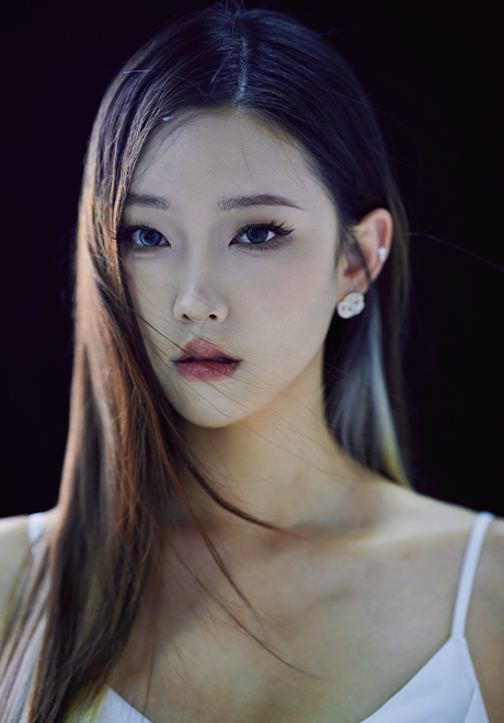 Angela Zhou headshot: wearing a white tank top in front of a black background