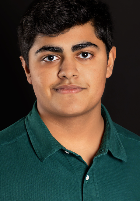Arav Arand headshot: smiling in a green polo shirt