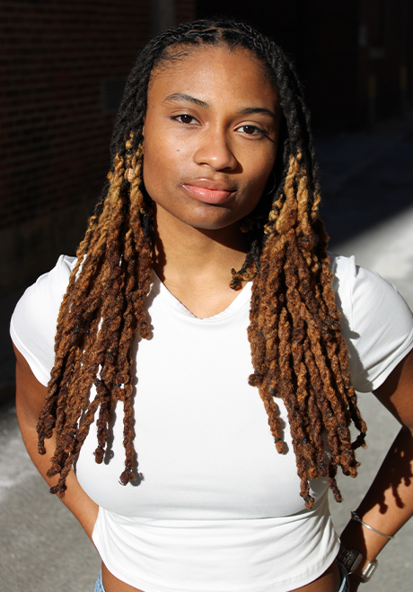 Heaven Williams headshot: wearing a white shirt in front of a black background