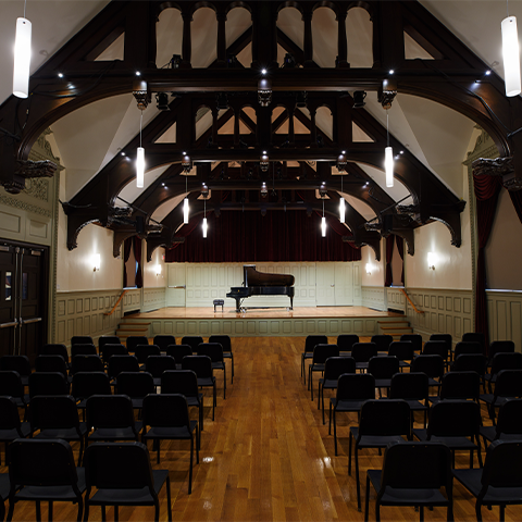 Seully hall: a stage with a piano on it and chairs in the audience