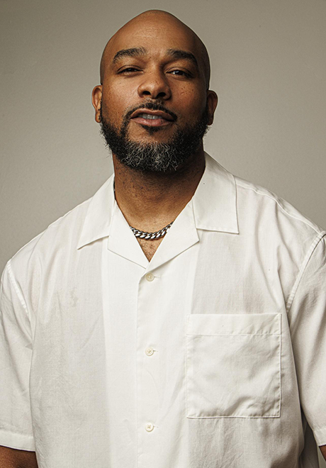 anthony burrell headshot, wearing white shirt and posing