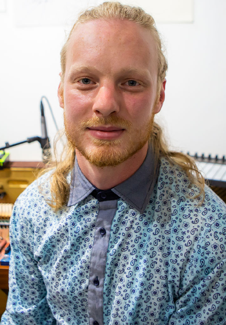 Nate Tucker headshot: wearing blue button down shirt