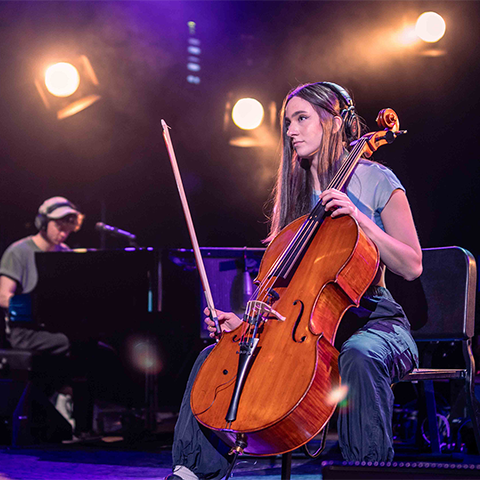 Elaina Spiro playing the cello on stage