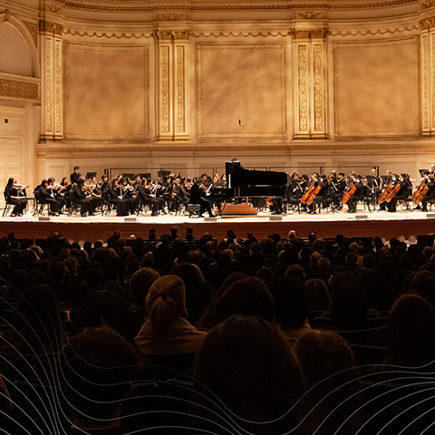 Boston Conservatory Orchestra performing on stage in a concert hall
