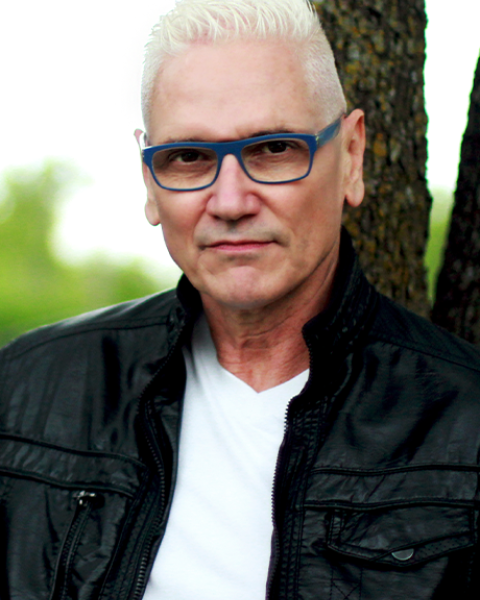 David Gately headshot in leather jacket and white shirt