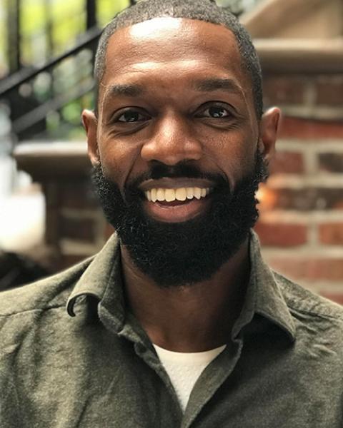 Ramone Owens smiling in green shirt