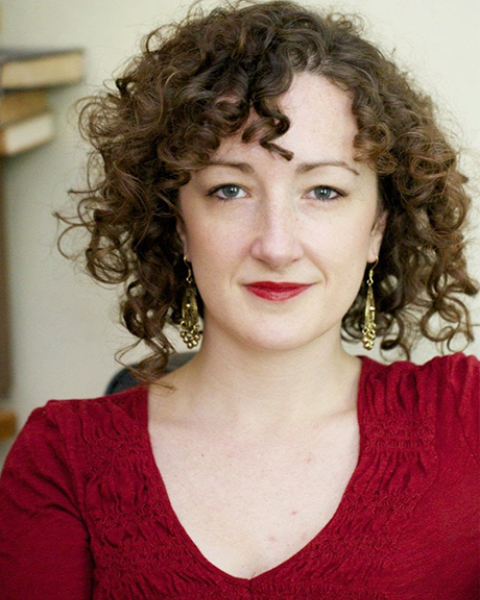 Amanda Friou headshot: smizing in red shirt