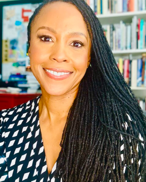 Angela Schiller headshot; headshot in black and white polka dot shirt