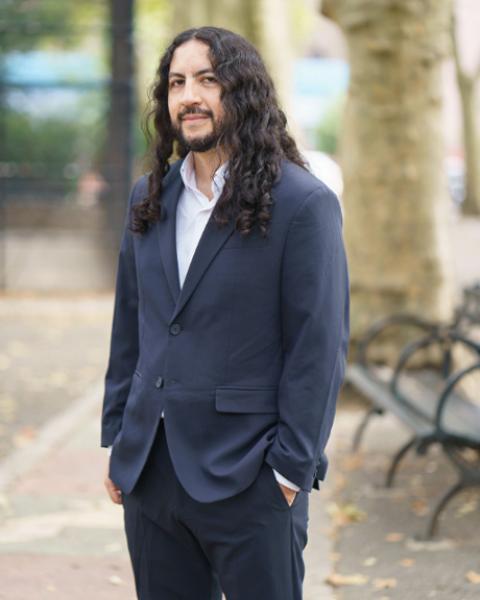 Manuel Garcia-Orozco headshot: smiling in suit