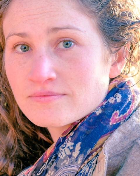 Sarah Konner headshot: wearing a blue scarf.