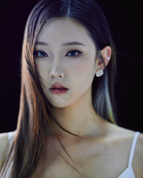 Angela Zhou headshot: wearing a white tank top in front of a black background