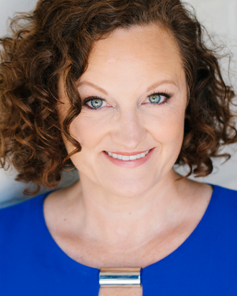 Gina Beck headshot: smiling in a blue shirt