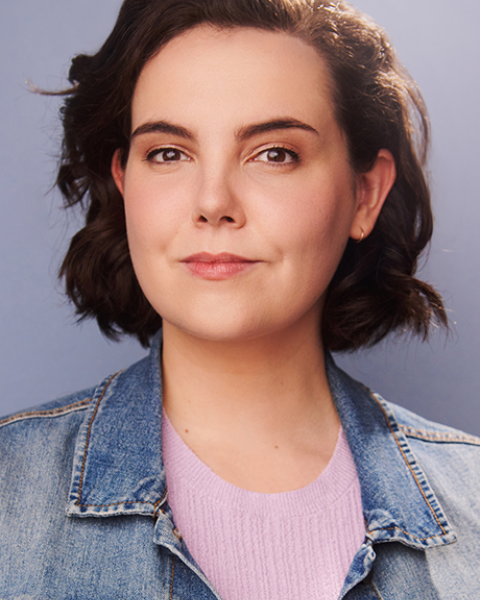 Allison Beauregard headshot: grinning in denim jacket and pink top