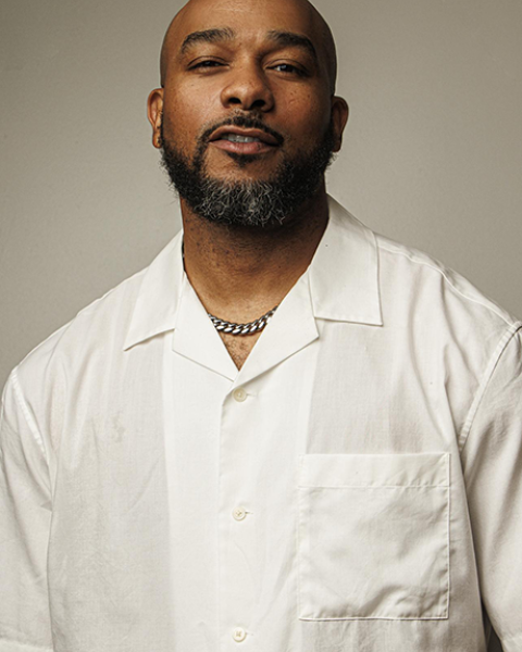 anthony burrell headshot, wearing white shirt and posing