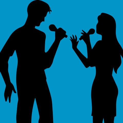 silhouette of two people singing
