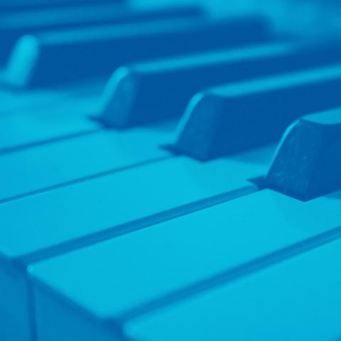 Close up of piano keys with a blue filter