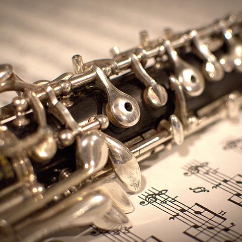 Picture of an Oboe sitting on top of sheet music