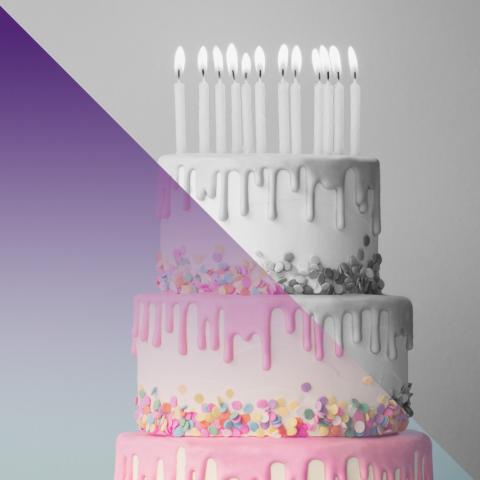 Three tier birthday cake with candles, with a half purple half gray overlay/