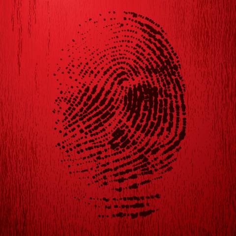A black thumb print on a red background. 