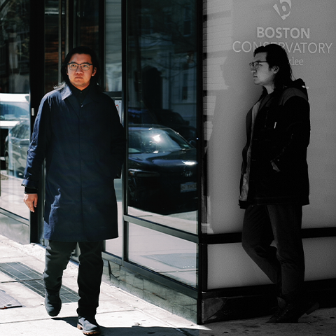 A photo of Yinfei Li, on the left side the image is in full color and is walking on the sidewalk, on the right side the photo is in black and white and they are leaning against the BCB building. 