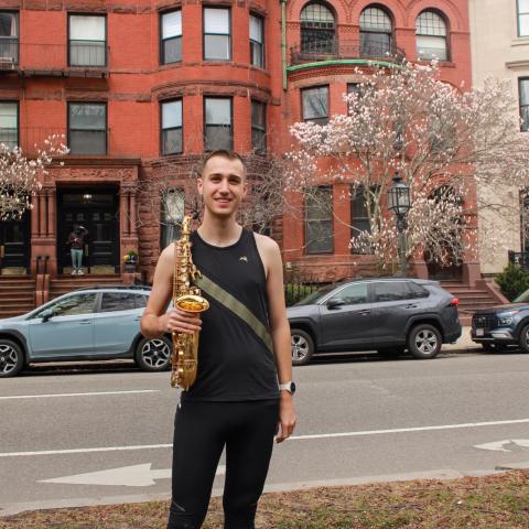 Xander Dawson with his saxophone on the Comm Ave Mall