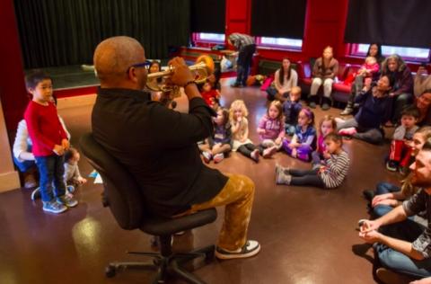 Man playing the trumpet during a KidsJam event
