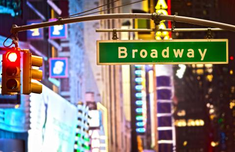 A stoplight and street sign that says Broadway