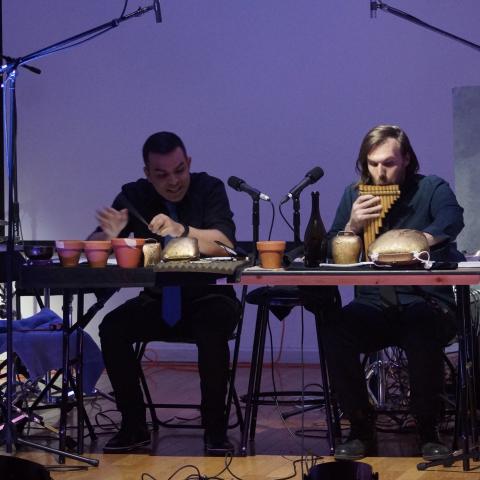 Piero Guimaraes and Josh Perry playing percussive instruments