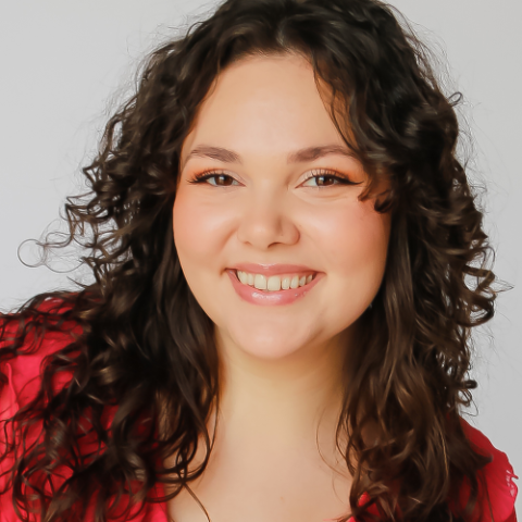 Rachel Da Silva headshot; smiling in red shirt