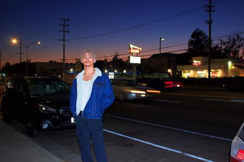 Asher Stevens standing on a city street at twilight