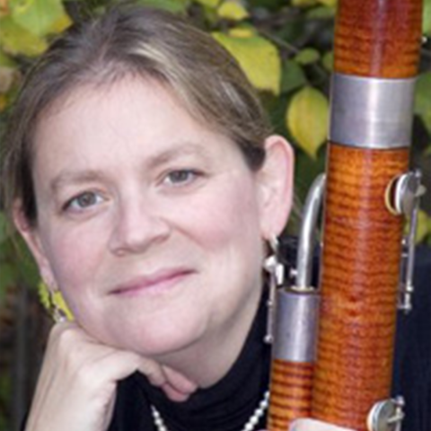 Margaret Phillips headshot holding bassoon