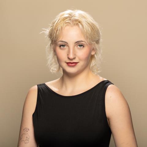 Aidan Robbins headshot: posing in a black tank top