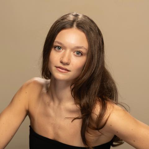 Ana Perez Yudin headshot: posing wearing a black tube top