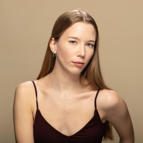 Anna Keklak headshot, posing in a black tank top
