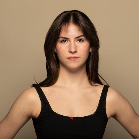 Campbell Colimore headshot, posing in black tank top