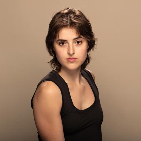 Demetra Mutz headshot: posing in black tank top