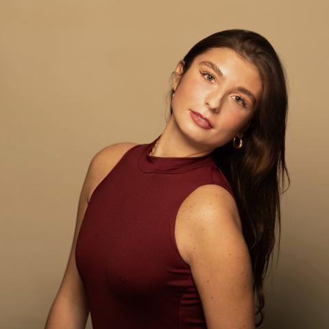 Emersyn Novach headshot: posing in a red top