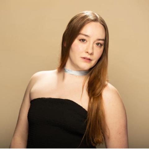 Emily Crone headshot: posing in black tube top